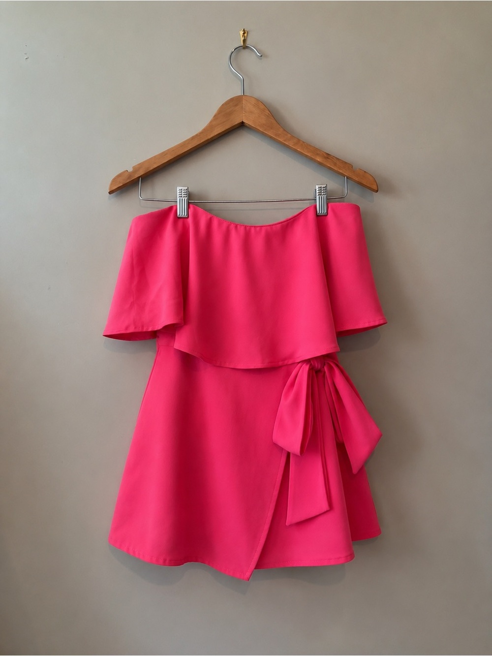 Bright pink strapless ruffle romper with side bow